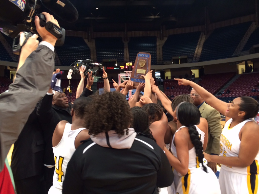 Coach Emanuel Bell, far left, celebrates with the Wenonah Lady Dragons  after winning the state 5A girls' basketball championship on Feb. 28 at the BJCC. (Photo by: Chanda Temple) 