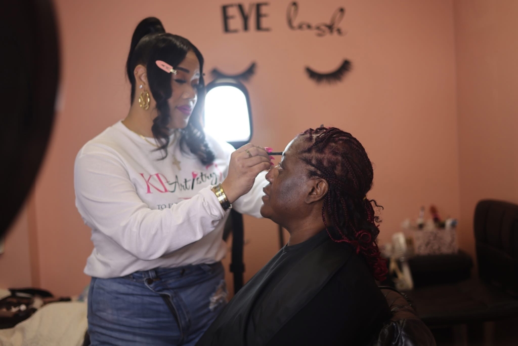 Katasha applying makeup to Arica. (Photo by Daniel Roth)