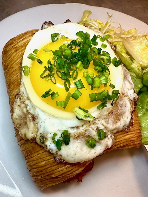 The Croissant Croque Madame is made with Kristen Farmer Hall’s cult-status croissant and offered with either the Parisian ham or with with roasted local mushrooms for a vegetarian version. (Photo by Chanda Temple)